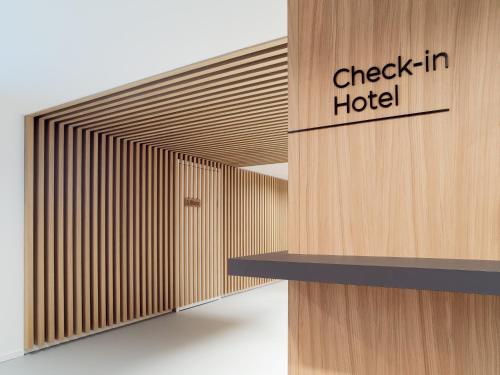 a lobby with a check in hotel sign on a wall at Hotel Neu-Schönstatt in Quarten