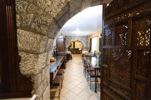 an archway in a room with tables and chairs at Amfitrion in Gythio