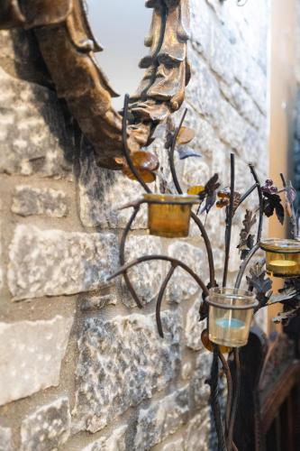 a wrought iron candle holder on a stone wall at Amfitrion in Gythio