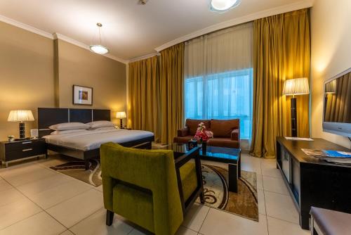 a hotel room with a bed and a living room at Gulf Oasis Hotel Apartments Fz LLC in Dubai