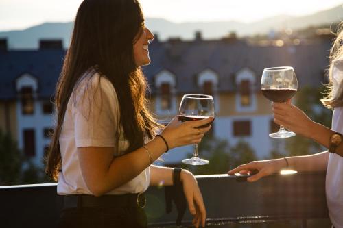 a group of three women holding glasses of wine at Oroel Hotel & SPA in Jaca