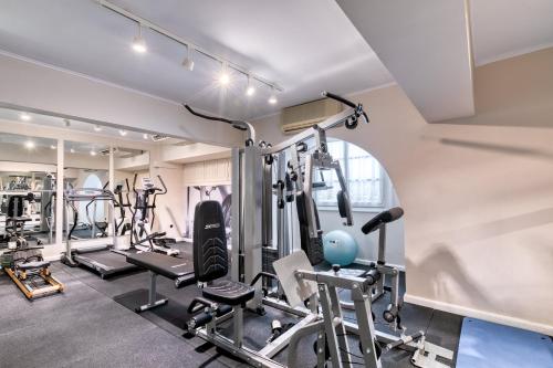 a gym with several treadmills and exercise bikes at Hotel Leto Hydra in Hydra