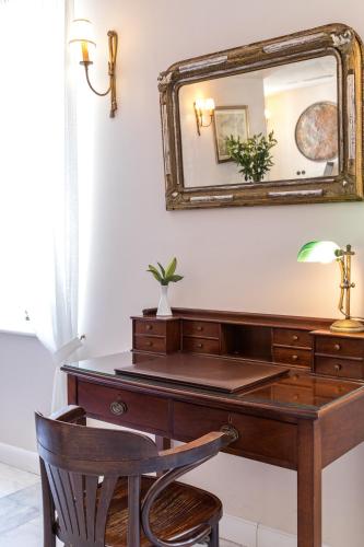 a desk with a mirror and a chair at Hotel Leto Hydra in Hydra