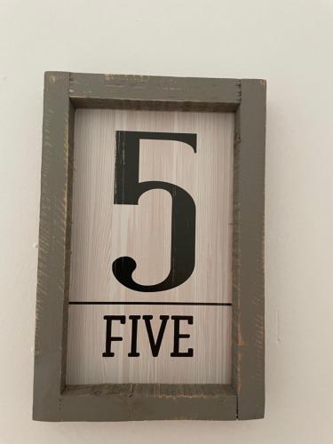 a baseball sign with the number five on it at B&B Thérèse 13 in Ginosa Marina