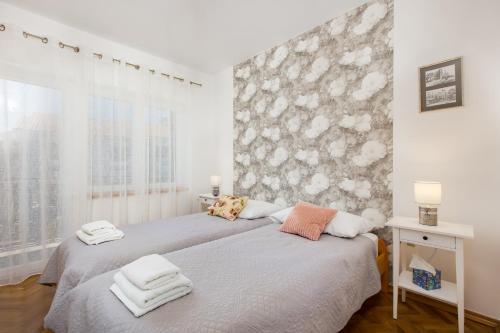 sypialnia z 2 łóżkami i ręcznikami w obiekcie AnD Charming apartment in Vantačići w mieście Malinska