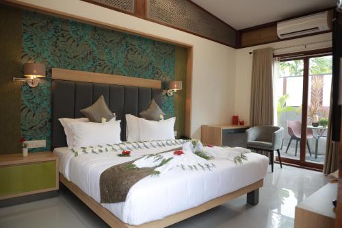 A bed or beds in a room at Lago Leisure Resort & Spa