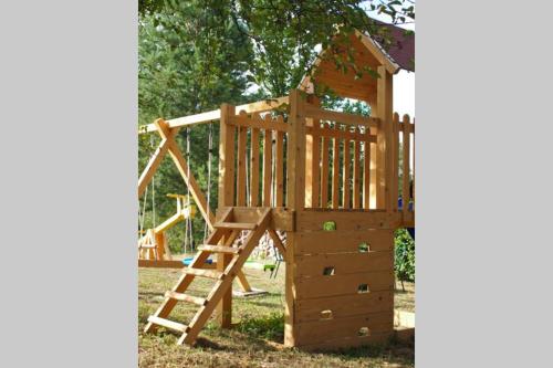 a wooden play set with a ladder and a wooden playset at ČAROBNA ŠUMA ***(magic forest) in Karlovac
