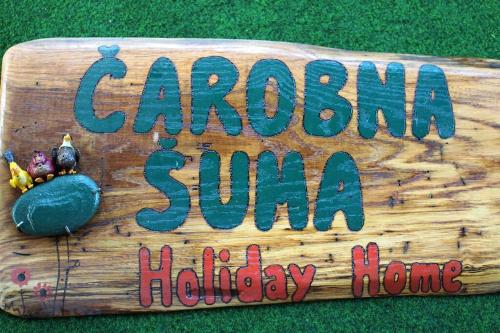 a wooden sign that says carolina sun holiday home at ČAROBNA ŠUMA ***(magic forest) in Karlovac