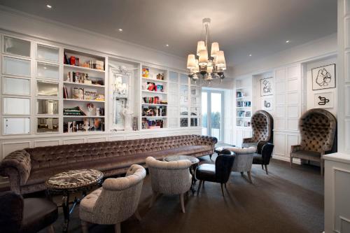 a bar with a couch and chairs in a room at The Marly Boutique Hotel in Cape Town