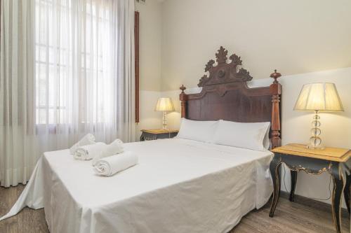 a bedroom with a large bed with towels on it at Can Bombarda in Llubí