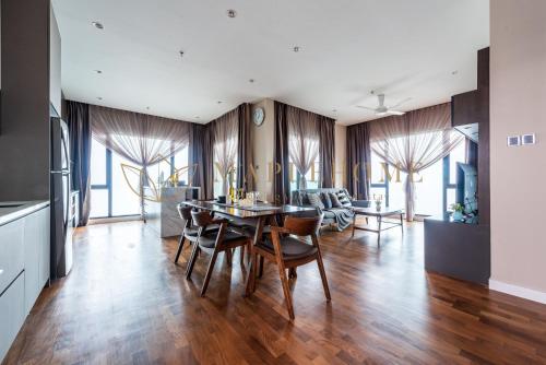 a kitchen and dining room with a table and chairs at Geo38 Premier Suites Genting Highlands in Genting Highlands