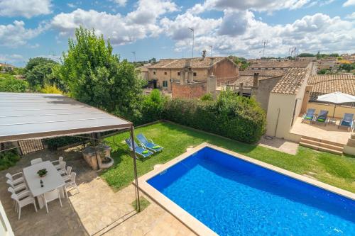 a view of a backyard with a swimming pool at Can Bombarda in Llubí