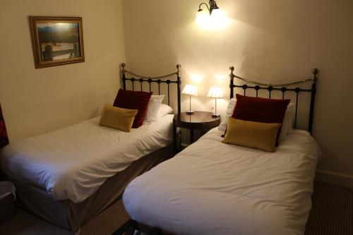 A bed or beds in a room at The Hostelrie at Goodrich 