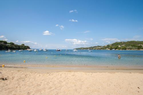 a beach with a bunch of boats in the water at Amouage Boutique Home in Skiathos Town