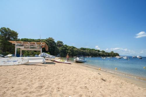 a beach with boats and a gazebo on it at Amouage Boutique Home in Skiathos Town