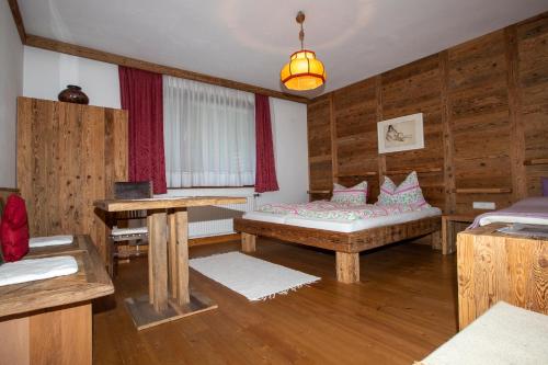 a room with a bed and a table in it at Haus Kogler in Inzersdorf im Kremstal