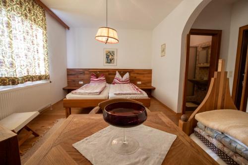 a room with two beds and a wine glass on a table at Haus Kogler in Inzersdorf im Kremstal