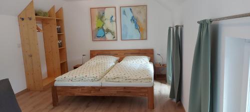 a bedroom with a bed with a wooden frame at Ferienhaus Richtermühle in Sebnitz