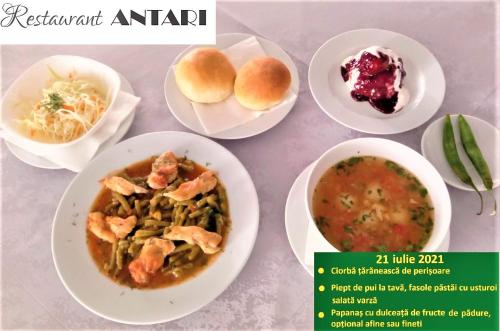 a table with plates of food and bowls of soup at Antari in Slatina