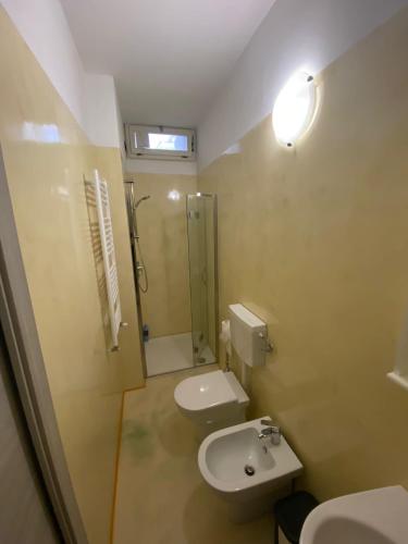 a bathroom with a toilet and a sink and a shower at Macloud pub B&B in Sarnico