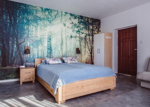 1 dormitorio con 1 cama con una pintura en la pared en Brzozowy Zaułek en Bydlino