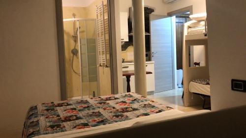 a room with a bed and a bathroom with a shower at Macloud pub B&B in Sarnico
