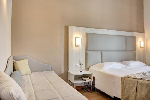 Postel nebo postele na pokoji v ubytování Hotel Caravel