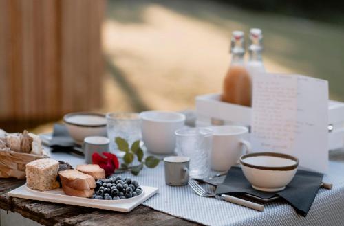 uma mesa com um prato de comida e chávenas de café em Lou Estela - L'essiccatoio em Moiola