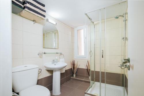a bathroom with a toilet and a sink and a shower at Lazaros Centre Apartment in Larnaca