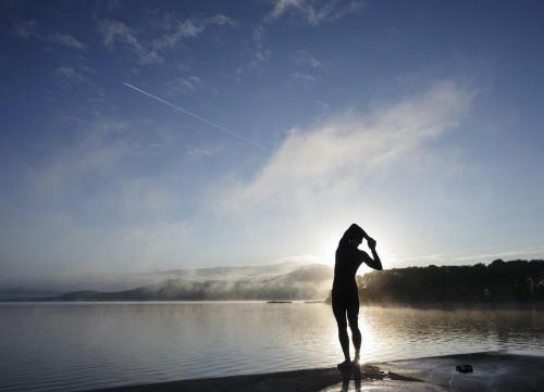 a person standing on a beach flying a kite at Old Court Holiday Homes Terryglass 4 Bed No 12 by Trident Holiday Homes in Terryglass