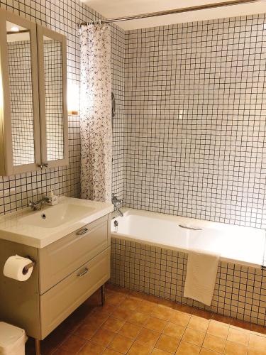 a bathroom with a white tub and a sink at American Village Resort in Taipei