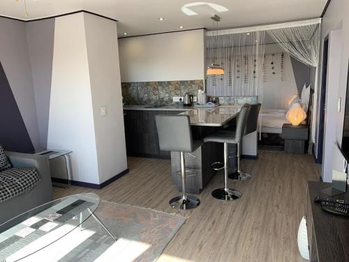 a kitchen with a table and chairs in a room at Farr Out Guest House in Paternoster
