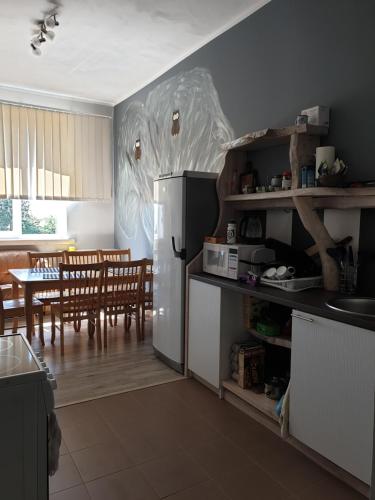 a kitchen with a refrigerator and a dining room at Türi Vibukooli majutus in Türi