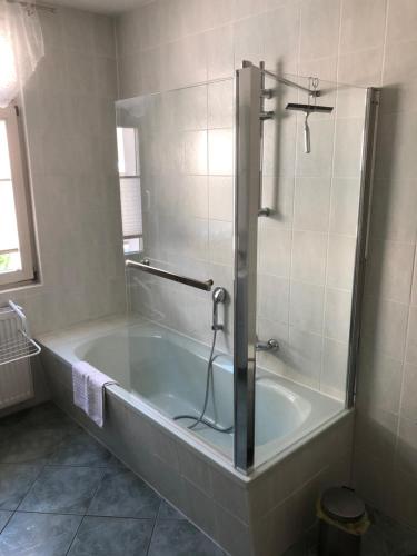 a bathroom with a bath tub with a shower at Ferienwohnung an der Therme in Bad Schandau