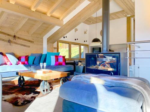 a living room with blue couches and a tv at Chalet Azalée, Montriond, Morzine, Avoriaz in Montriond