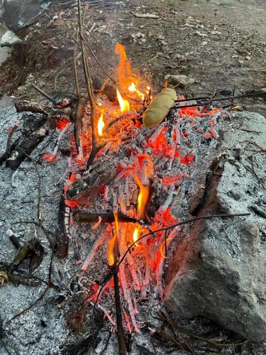 a campfire with flames and a bagel on it at Jeskyně Jánská in Janská