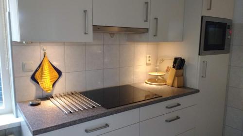 a kitchen with a counter with a light on it at b&b de Vlinder in Hardenberg