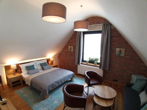 a bedroom with a bed and a window at Kafé Ořech in Mnichovo Hradiště