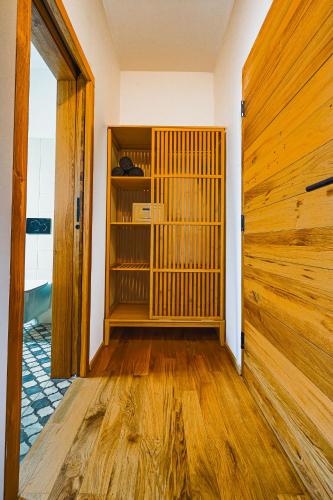 a room with a book shelf and a wooden door at Kafé Ořech in Mnichovo Hradiště