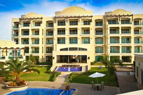 an exterior view of a hotel with a swimming pool at Diamond Bay in Mazatlán