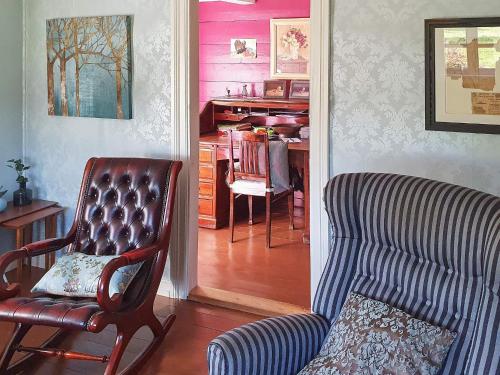 a living room with a couch and a chair and a desk at 6 person holiday home in Fonnes-By Traum in Fonnes
