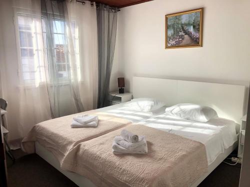a bedroom with a white bed with towels on it at Sandra Hause in Ponta Delgada