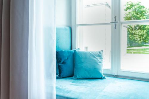 a blue couch sitting in front of a window at CMA Stift Ossiach in Ossiach