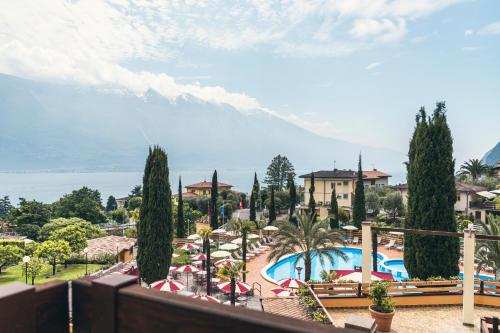 a view of a resort with a swimming pool at Hotel Caravel in Limone sul Garda