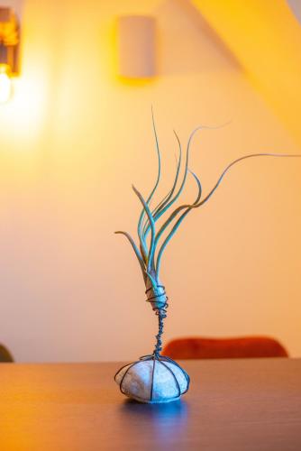 a vase with a plant in it on a table at CMA Stift Ossiach in Ossiach