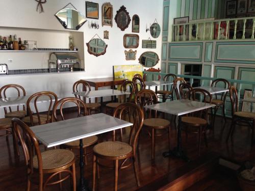 a room with tables and chairs in a restaurant at Hotel Aliki in Symi