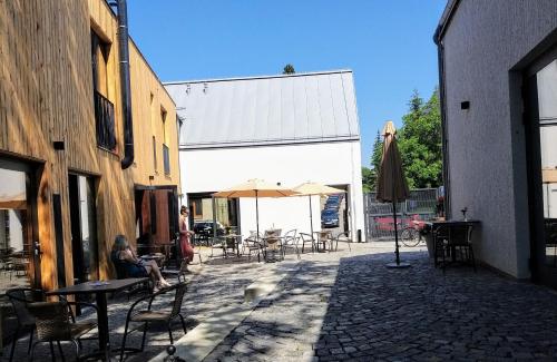 a person sitting at a table in a patio at Kafé Ořech in Mnichovo Hradiště