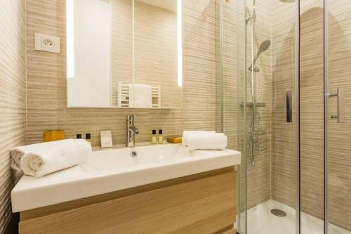 une salle de bain avec un lavabo et une douche dans l'établissement HSH Cosy Apartment Bidassoa Gambetta, à Paris