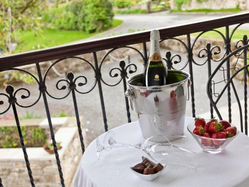 a bottle of champagne and a bucket of strawberries on a table at Littlebeck Warren in Whitehaven
