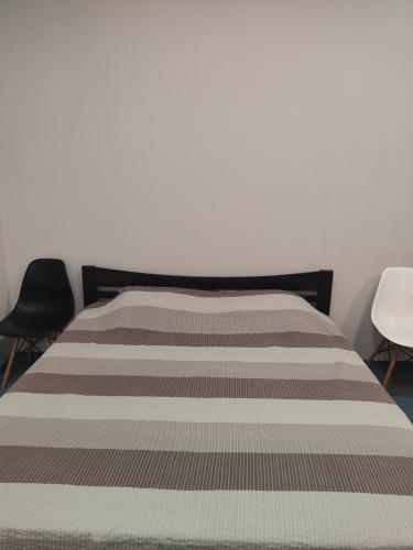 リヴィウにあるАпартаменти у Львовіのベッド1台(椅子2脚付)
